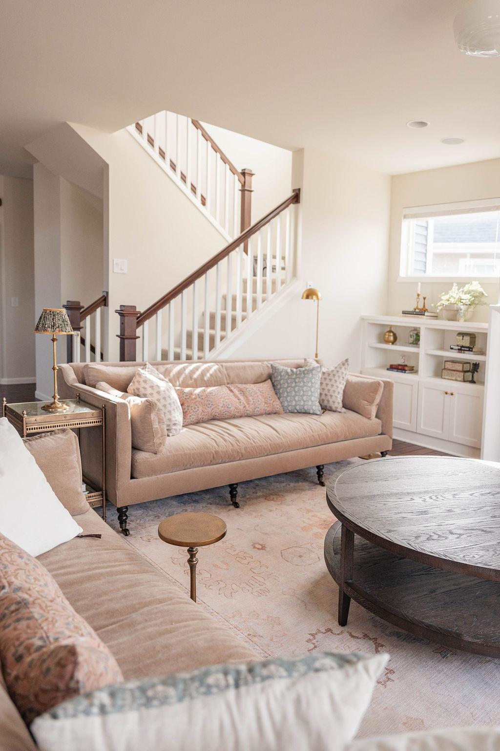 Windy Peak living room designed by Middle West Studio, with layered sofas, brass lamps, and a round timber table